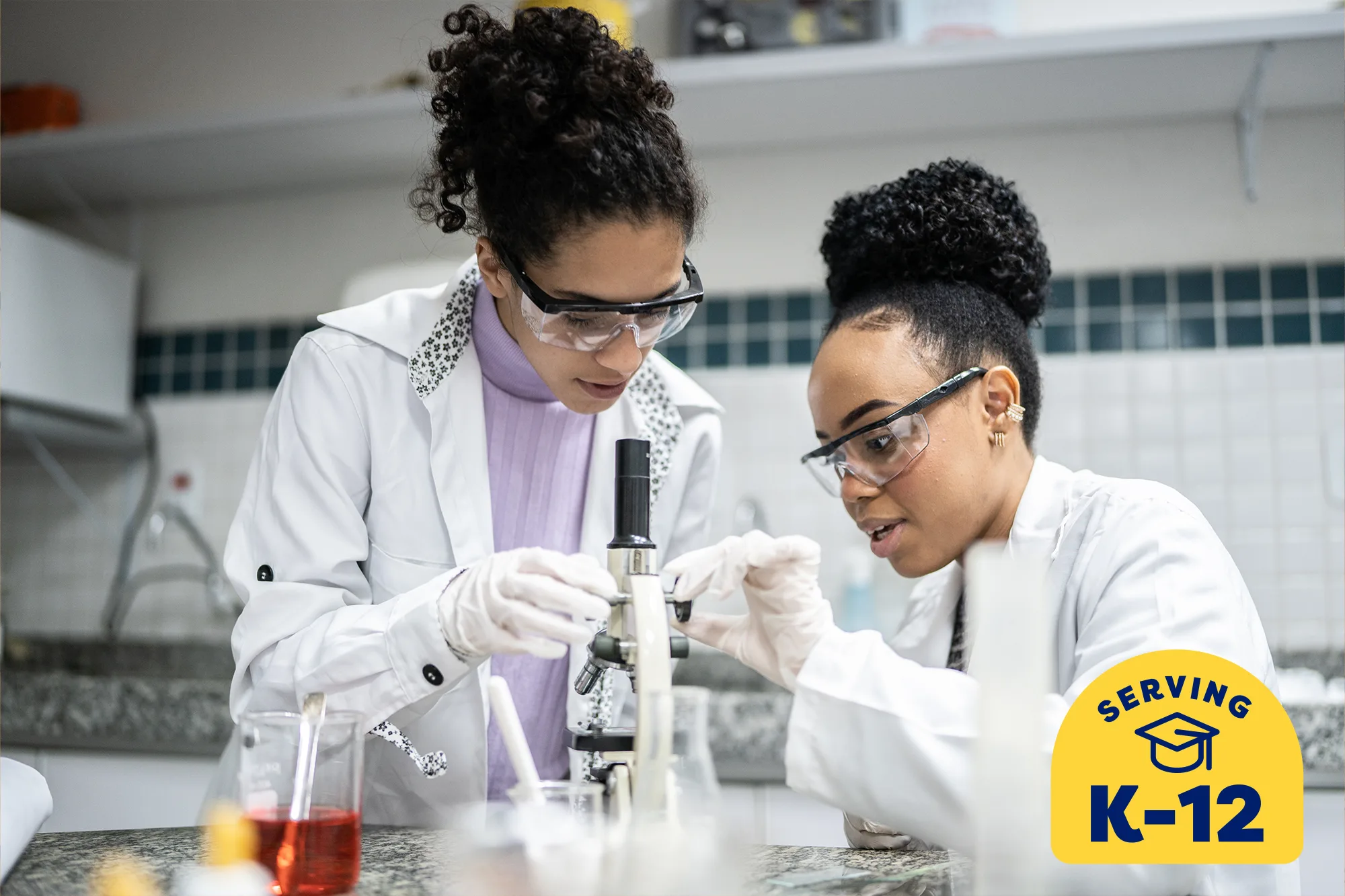 2 science students working together using a microscope