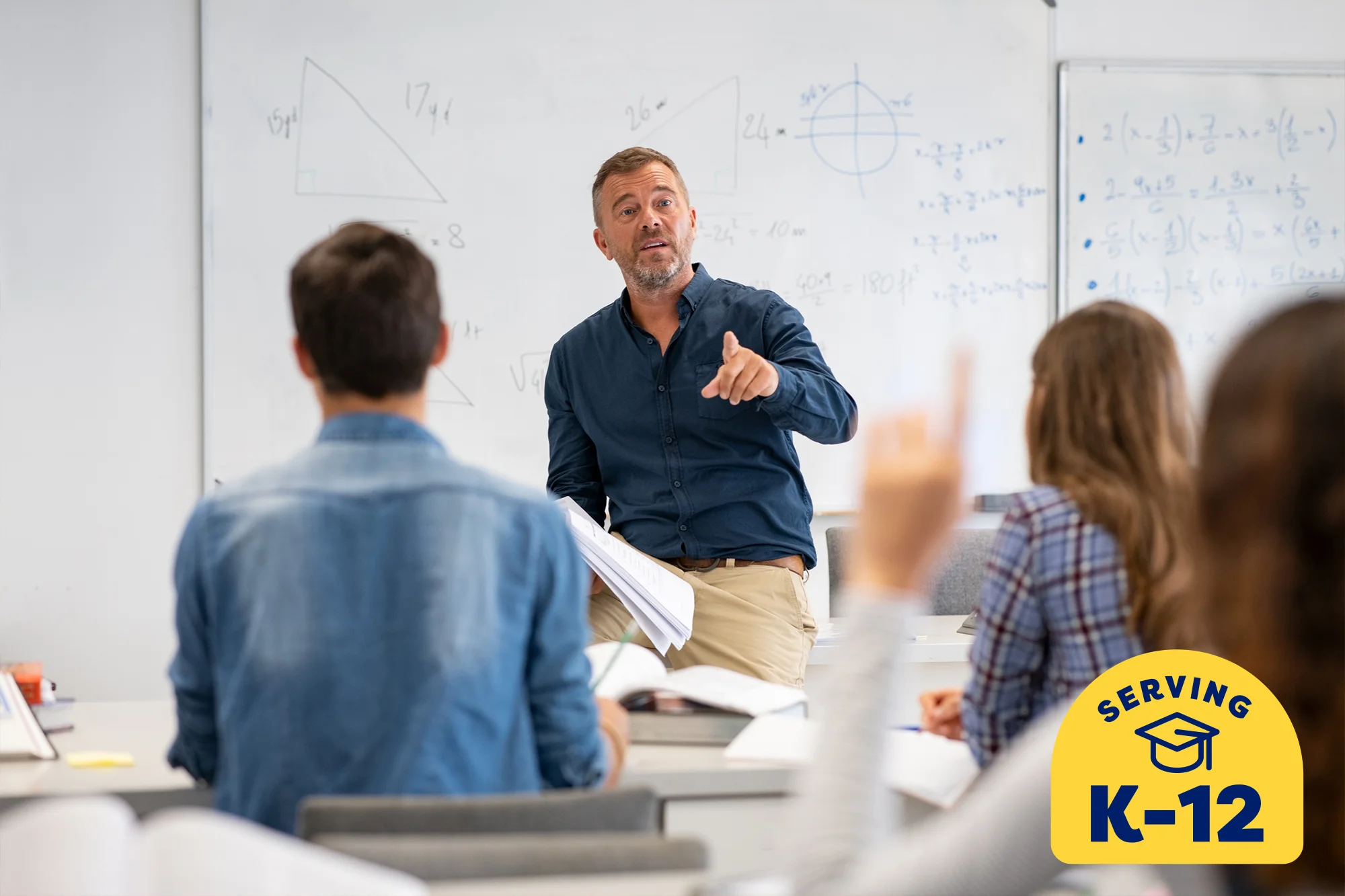 trigonometry teacher sitting on his desk in front of the classroom teaching the students