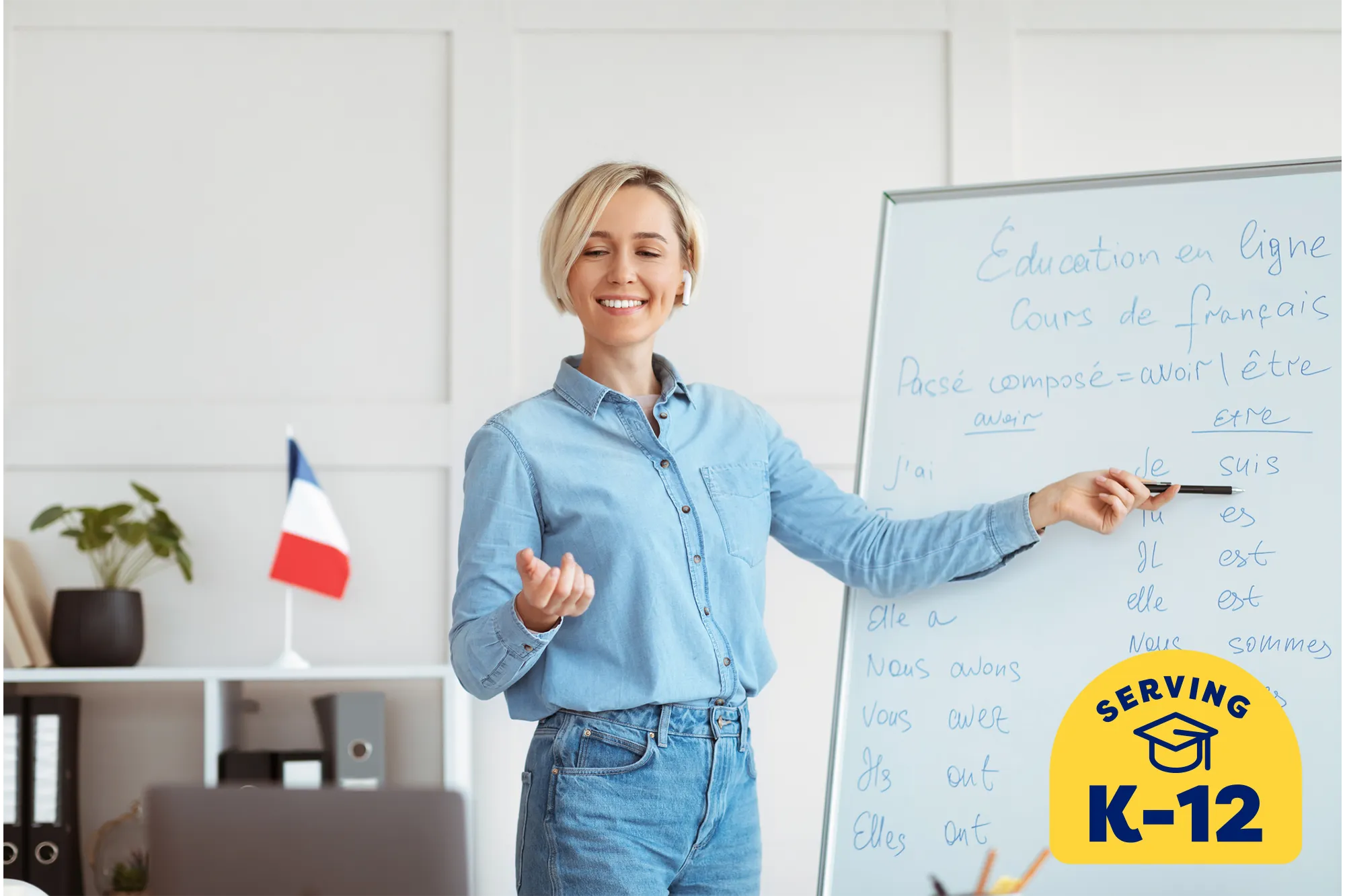 a french tutor writing a lesson on a while marker board