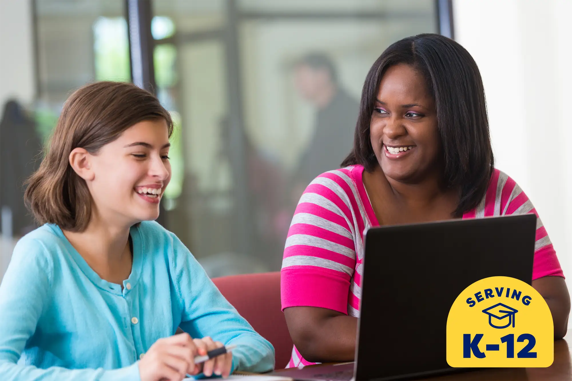 tutor laughing with her middle school student