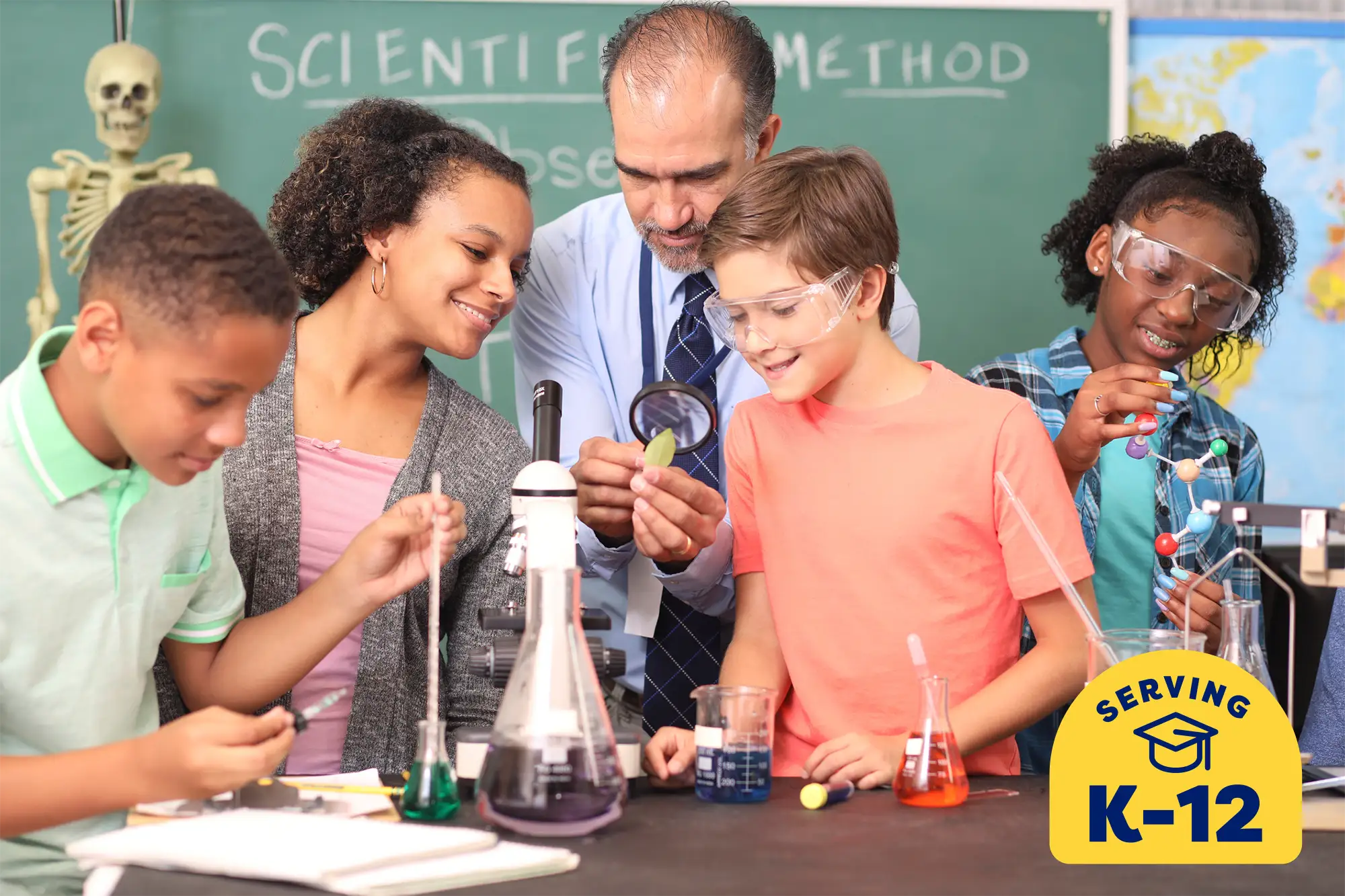 group of middle school students in a science class working on an experiment with their teacher